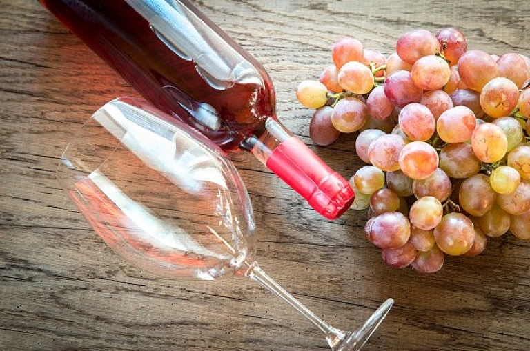 Rose wine with bunch of grape